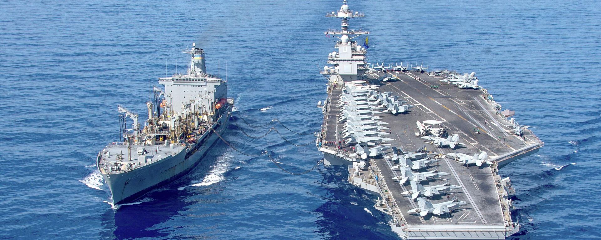 USS Gerald R. Ford aircraft carrier refuels from the underway replenishment oiler USNS Laramie in the eastern Mediterranean Sea, Oct. 11, 2023 - Sputnik International, 1920, 14.02.2026