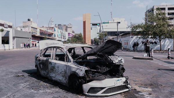 A vehicle sits charred after being set on fire, on a road in Guadalajara, Jalisco state, Mexico, Sunday, Feb. 22, 2026, after the death of the leader of the Jalisco New Generation Cartel, Nemesio Rubén Oseguera Cervantes, known asEl Mencho. - Sputnik International