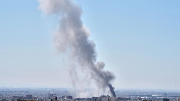 A plume of smoke rises after a strike in Tehran, Iran, Sunday, March 1, 2026. - Sputnik International