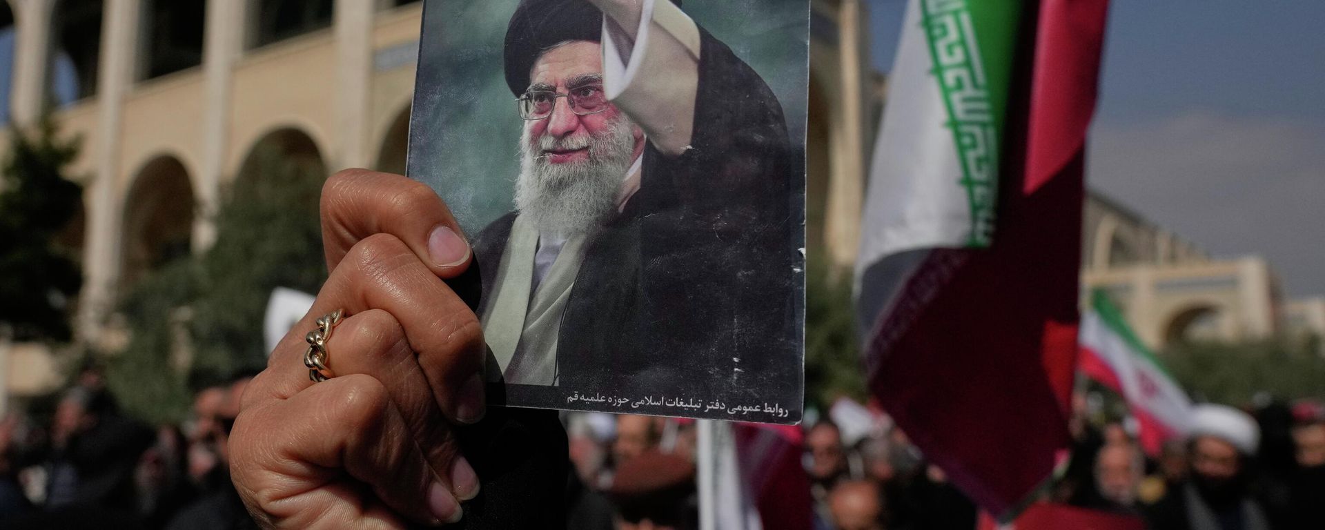A woman holds up a picture of the late Iranian Supreme Leader Ayatollah Ali Khamenei as government supporters march against the ongoing U.S.-Israeli military campaign after Friday prayers at the Imam Khomeini Grand mosque in Tehran, Iran, Friday, March 6, 2026. (AP Photo/Vahid Salemi) - Sputnik International, 1920, 06.03.2026