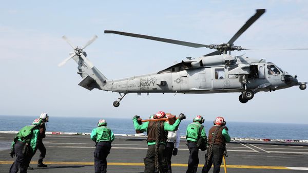 In this March 20, 2017 photograph, an MH-60 helicopter takes off from the USS George H.W. Bush as it travels toward the Strait of Hormuz.  - Sputnik International