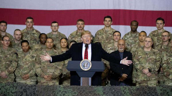 President Donald Trump, center, with Afghan President Ashraf Ghani and Joint Chiefs Chairman Gen. Mark Milley, behind him at right, while addressing members of the military during a surprise Thanksgiving Day visit, Thursday, Nov. 28, 2019, at Bagram Air Field, Afghanistan - Sputnik International