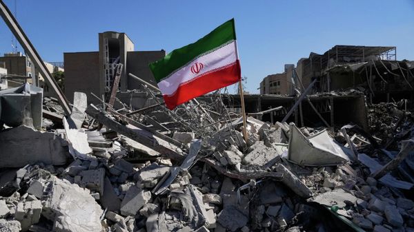 An Iranian flag is placed among the ruins of a police station struck Monday during the U.S.–Israeli military campaign in Tehran, Iran, Tuesday, March 3, 2026. (AP Photo/Vahid Salemi) - Sputnik International