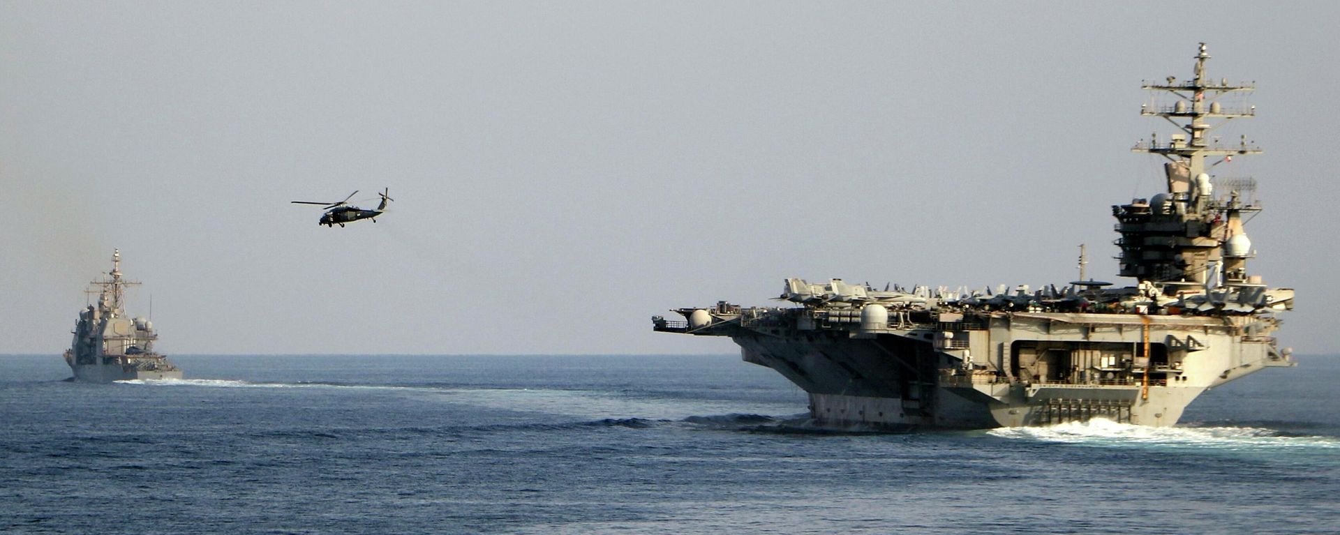 The aircraft carrier USS Dwight D. Eisenhower and other warships crosses the Strait of Hormuz into the Persian Gulf on Sunday. File photo. - Sputnik International, 1920, 16.04.2026