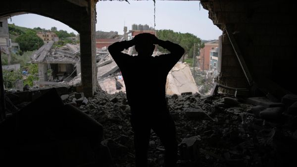 Assem Abdallah reacts as he enters his friend apartment destroyed in a Israeli airstrike in Kfar Roumman, southern Lebanon, Friday, April 17, 2026, following a ceasefire between Israel and Hezbollah. - Sputnik International