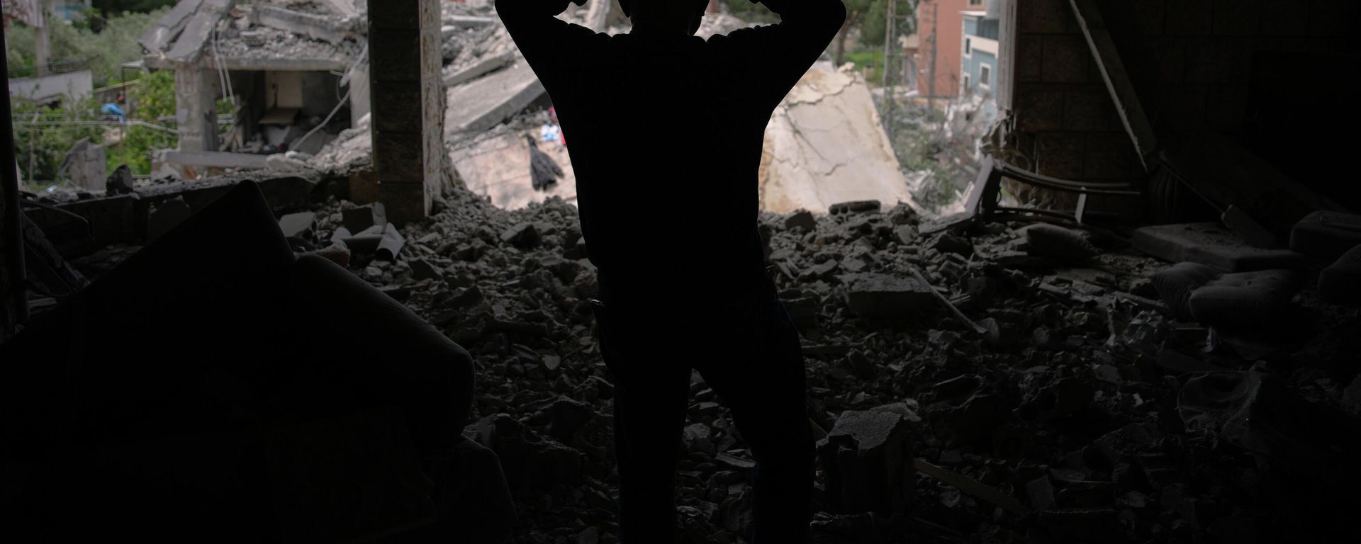 Assem Abdallah reacts as he enters his friend apartment destroyed in a Israeli airstrike in Kfar Roumman, southern Lebanon, Friday, April 17, 2026, following a ceasefire between Israel and Hezbollah. - Sputnik International, 1920, 12.10.2026