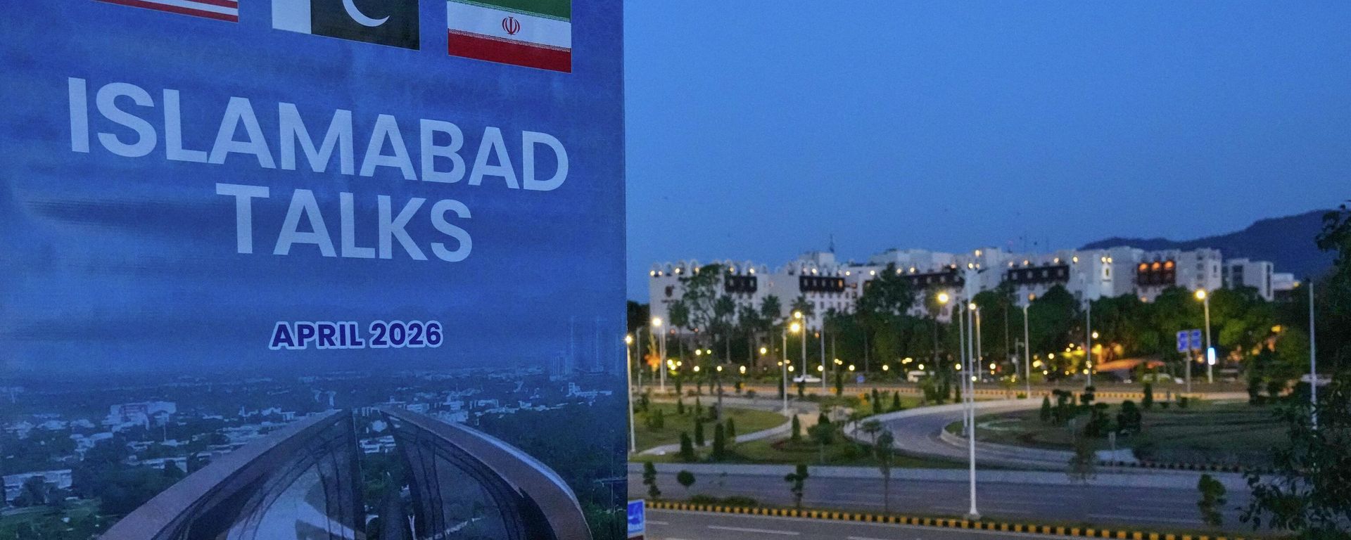 A billboard of the U.S. Iran talks is seen near Serena Hotel, the venue for the U.S. Iran officials meeting, in Islamabad, Pakistan, Sunday, April 12, 2026. (AP Photo/Anjum Naveed) - Sputnik International, 1920, 25.08.2026