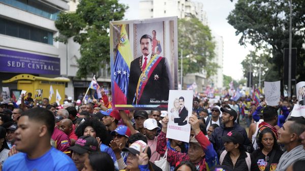 Government supporters carry portrait of former President Nicolas Maduro during a rally marking the anniversary of the 1958 coup that overthrew Venezuelan dictator Marcos Pérez Jiménez, in Caracas, Venezuela, Jan. 23, 2026.  - Sputnik International