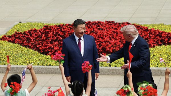 Children hold Chinese and U.S. flags, as U.S. President Donald Trump participates in a welcome ceremony with Chinese President Xi Jinping at the Great Hall of the People in Beijing, China, May 14, 2026.  - Sputnik International