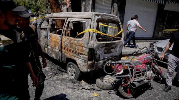 Syrian security personnel inspect a burned vehicles near the Four Seasons Hotel after two explosions rocked the area earlier while Syrian President Ahmad al-Sharaa was meeting French President Emmanuel Macron at the presidential palace, in Damascus, Syria - Sputnik International