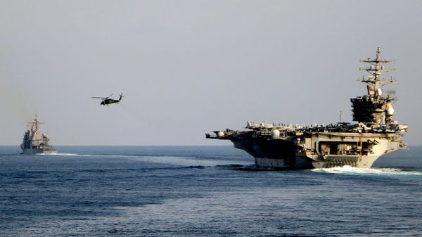The aircraft carrier USS Dwight D. Eisenhower and other warships crosses the Strait of Hormuz into the Persian Gulf on Sunday, Nov. 26, 2023 - Sputnik International
