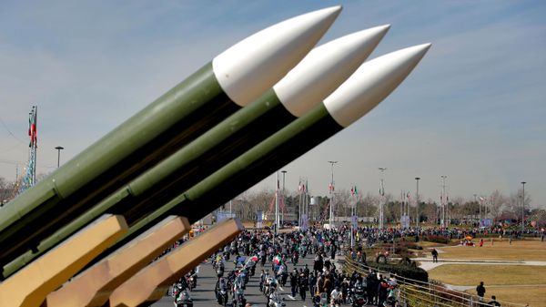 Iranians drive past missiles by their motorcycles during a rally marking the 42nd anniversary of the Islamic Revolution, at Azadi (Freedom) Square in Tehran, Iran, Wednesday, Feb. 10, 2021 - Sputnik International