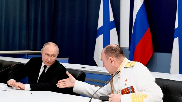 Russian President and Supreme Commander-in-Chief Vladimir Putin during a meeting with naval command at the Main Admiralty in St. Petersburg on Navy Day, July 26, 2026. Commander-in-Chief of the Russian Navy Alexander Moiseev is seen on the right. - Sputnik International