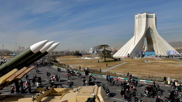 Iranians drive past missiles by their motorcycle during a rally marking the 42nd anniversary of the Islamic Revolution, at Azadi (Freedom) Square in Tehran, Iran, Wednesday, Feb. 10, 2021 - Sputnik International