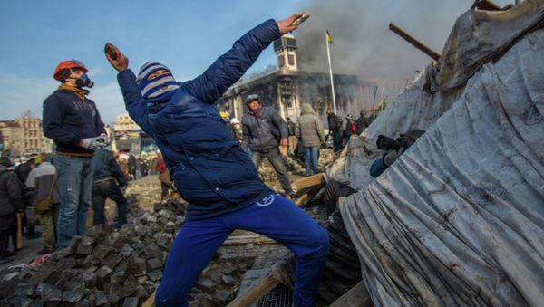 A protester throws stone on Maidan square in Kiev, Ukraine, Feb 19, 2014 A protester throws stone on Maidan square in Kiev, Ukraine, Feb 19, 2014 - Sputnik International