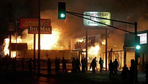 People gather around the burning stores in Ferguson People gather around the burning stores in Ferguson - Sputnik International