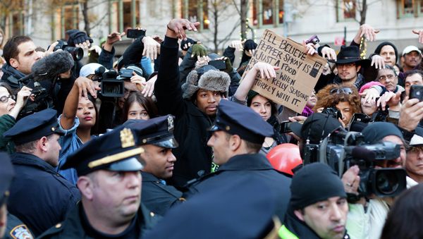 Occupy Wall Street protestors show they disapprove of police demanding that drums not be played in Zuccotti park due to a noise complaint from nearby residents on Thanksgiving day, Thursday, Nov. 24, 2011, in New York. Although the crowd insisted they had a right to play, the drummer in question opted to refrain from playing to avoid a confrontation with police. - Sputnik International