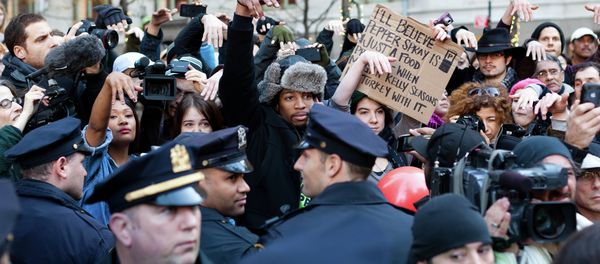 Occupy Wall Street protestors show they disapprove of police demanding that drums not be played in Zuccotti park due to a noise complaint from nearby residents on Thanksgiving day, Thursday, Nov. 24, 2011, in New York. Although the crowd insisted they had a right to play, the drummer in question opted to refrain from playing to avoid a confrontation with police. - Sputnik International