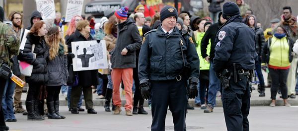Police officers monitor demonstrators blocking Public Square in Cleveland Tuesday, Nov. 25, 2014, during a protest over the weekend police shooting of Tamir Rice. The 12-year-old was fatally shot by a Cleveland police officer Saturday after he reportedly pulled a replica gun at the city park. Police officers monitor demonstrators blocking Public Square in Cleveland Tuesday, Nov. 25, 2014, during a protest over the weekend police shooting of Tamir Rice. The 12-year-old was fatally shot by a Cleveland police officer Saturday after he reportedly pulled a replica gun at the city park. - Sputnik International