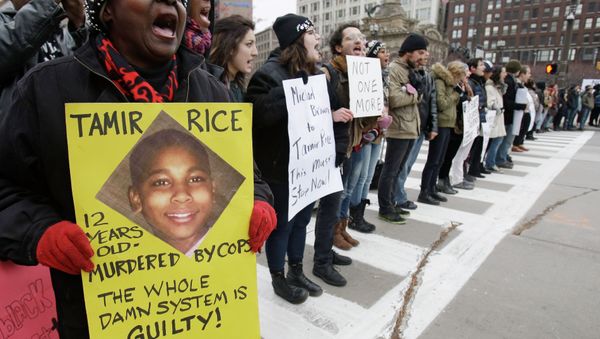 Demonstrators block Public Square Tuesday, Nov. 25, 2014, in Cleveland, during a protest over the weekend police shooting of Tamir Rice. The 12-year-old was fatally shot by a Cleveland police officer Saturday after he reportedly pulled a replica gun at the city park. Demonstrators block Public Square Tuesday, Nov. 25, 2014, in Cleveland, during a protest over the weekend police shooting of Tamir Rice. The 12-year-old was fatally shot by a Cleveland police officer Saturday after he reportedly pulled a replica gun at the city park. - Sputnik International