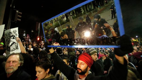 Members of the Berkeley Police Department are reflected in a mirror held up by a protester during a march against the New York City grand jury decision to not indict in the death of Eric Garner in Berkeley, California Members of the Berkeley Police Department are reflected in a mirror held up by a protester during a march against the New York City grand jury decision to not indict in the death of Eric Garner in Berkeley, California - Sputnik International
