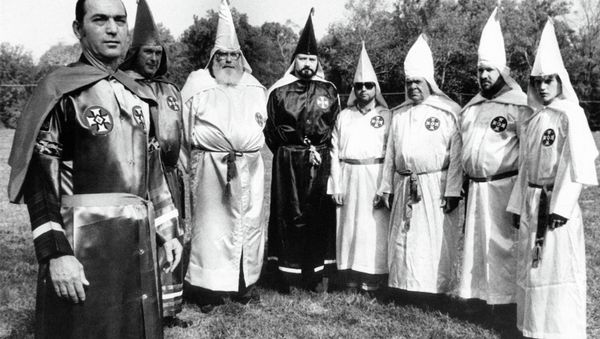 Tony La Ricci, far left, the head of the Maryland Independent Knights of the Ku Klux Klan, stands with seven members of the Klan, including Ron Glover, the fourth from the left in Baltimore, Nov. 12, 1979. - Sputnik International