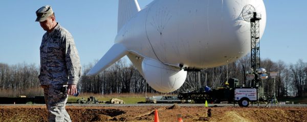 NORAD's Air Force Col. Chuck Douglass walks in front of an unmanned aerostat that is part of a new U.S. military cruise-missile defense system during a media preview, Wednesday, Dec. 17, 2014, in Middle River, Md. Military officials said a pair of helium-filled aerostats stationed in Maryland are intended provide early detection of cruise missiles over a large swath of the East Coast, from Norfolk, Va., to upstate New York, during a three-year test. JLENS, short for Joint Land Attack Cruise Missile Defense Elevated Netted Sensor System, will be fully implemented this winter. - Sputnik International