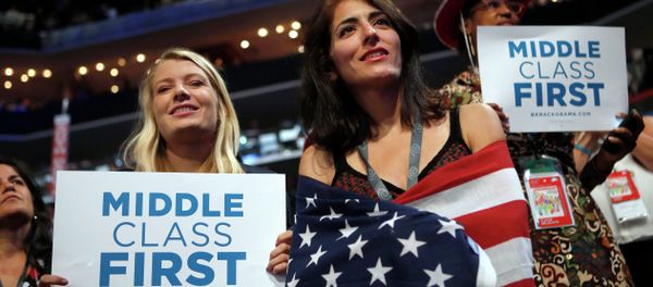 In this Sept. 5, 2012, file photo, delegates watch as former President Bill Clinton addresses the Democratic National Convention in Charlotte, N.C. Since 2008, the number of people who call themselves middle class has fallen by a fifth, according to a survey in January 2014 by the Pew Research Center, from 53 percent to 44 percent. - Sputnik International