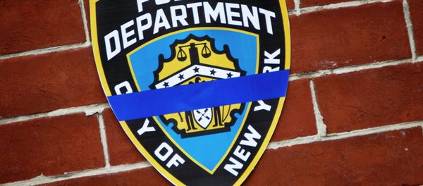 An NYPD logo is pictured on wall above makeshift memorial at the site where two police officers were shot in the head in the Brooklyn borough of New York, December 22, 2014. An NYPD logo is pictured on wall above makeshift memorial at the site where two police officers were shot in the head in the Brooklyn borough of New York, December 22, 2014. - Sputnik International