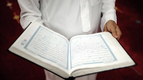 An imam holds the Quran after a prayer at a mosque An imam holds the Quran after a prayer at a mosque - Sputnik International