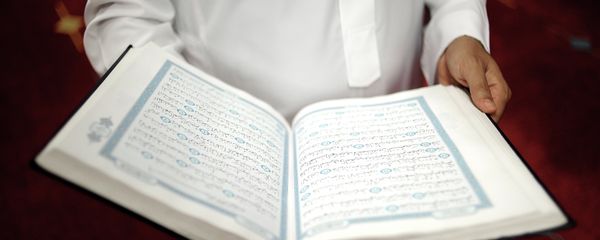 An imam holds the Quran after a prayer at a mosque An imam holds the Quran after a prayer at a mosque - Sputnik International