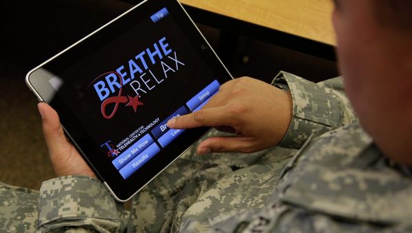 Sgt. Mark Miranda, a public affairs specialist stationed at Joint Base Lewis-McChord in Washington state, demonstrates the use of a program for tablet computers and smart phones that is designed to help calm symptoms of post-traumatic stress and traumatic brain injury, Friday, July 22, 2011. Miranda said he does not suffer from PTSD, but after trying the app, he said he may suggest its use to other soldiers who he has deployed with. - Sputnik International