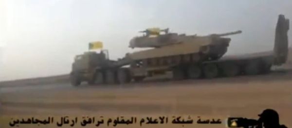 In this screenshot from a video uploaded to YouTube, a Hezbollah Brigades convoy transports an American-made M1 Abrams tank to the front lines of the battle with ISIL. - Sputnik International