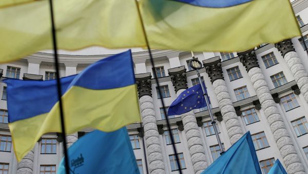 Ukrainian national flags, flags of Ukrainian trade unions and EU flag are seen during a mass rally in front of the Ukrainian cabinet of ministers building in Kiev October 15, 2014. Ukrainian national flags, flags of Ukrainian trade unions and EU flag are seen during a mass rally in front of the Ukrainian cabinet of ministers building in Kiev October 15, 2014. - Sputnik International