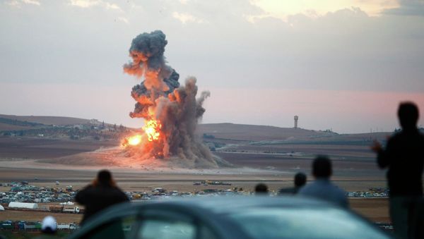 Smoke and flames rise over a hill near the Syrian town of Kobani after an airstrike, as seen from the Mursitpinar crossing on the Turkish-Syrian border in the southeastern town of Suruc in Sanliurfa province - Sputnik International