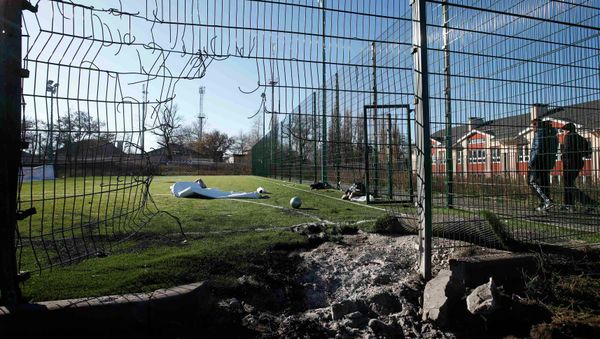A crater caused by shelling is seen near a school's soccer field in Donetsk, eastern Ukraine, November 6, 2014 - Sputnik International