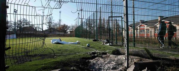 A crater caused by shelling is seen near a school's soccer field in Donetsk, eastern Ukraine, November 6, 2014 A crater caused by shelling is seen near a school's soccer field in Donetsk, eastern Ukraine, November 6, 2014 - Sputnik International