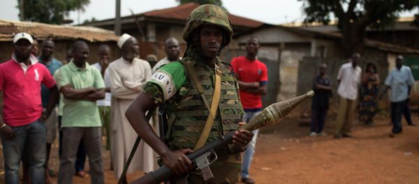 An African Union (AU) soldier stands guard outside a home in the Muslim neighbourhood of Kilometre 5 (PK5) in the capital Bangui An African Union (AU) soldier stands guard outside a home in the Muslim neighbourhood of Kilometre 5 (PK5) in the capital Bangui - Sputnik International
