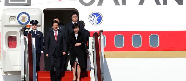 Japanese Prime Minister Shinzo Abe and his wife Akie arrive at the Beijing Capital International Airport November 9, 2014, to attend the Asia Pacific Economic Cooperation (APEC) meetings. Japanese Prime Minister Shinzo Abe and his wife Akie arrive at the Beijing Capital International Airport November 9, 2014, to attend the Asia Pacific Economic Cooperation (APEC) meetings. - Sputnik International