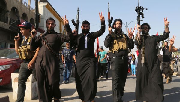 Shiite tribal fighters raise their weapons and chant slogans against the al-Qaida-inspired Islamic State of Iraq and the Levant (ISIL) in the northwest Baghdad's Shula neighborhood, Iraq, Monday, June 16, 2014. Sunni militants captured a key northern Iraqi town along the highway to Syria early on Monday, compounding the woes of Iraq's Shiite-led government a week after it lost a vast swath of territory to the insurgents in the country's north. Shiite tribal fighters raise their weapons and chant slogans against the al-Qaida-inspired Islamic State of Iraq and the Levant (ISIL) in the northwest Baghdad's Shula neighborhood, Iraq, Monday, June 16, 2014. Sunni militants captured a key northern Iraqi town along the highway to Syria early on Monday, compounding the woes of Iraq's Shiite-led government a week after it lost a vast swath of territory to the insurgents in the country's north. - Sputnik International