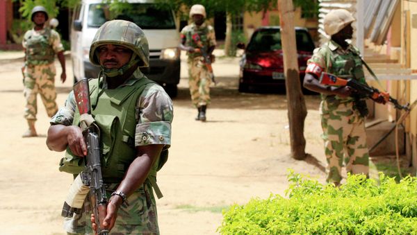 In this Thursday, June 6, 2013 file photo Nigerian soldiers stand guard at the offices of the state-run Nigerian Television Authority in Maiduguri, Nigeria - Sputnik International