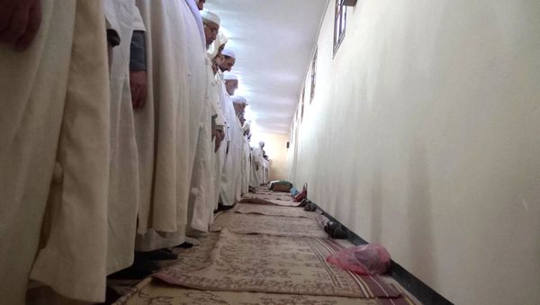 In this image taken Friday Feb. 7, 2014 Muslims pray in honor of Azzedine Babaousmail, a Berber who died of his wounds on Thursday in Algeria's desert city of Ghardaia, southern Algeria, bringing to five the number killed during weeks of violence between two rival communities in Ghardaia - Sputnik International
