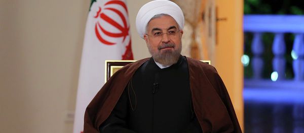 In this photo released by the Iranian Presidency Office, President Hassan Rouhani attends an interview with the state-run TV in Tehran, Iran, on Monday, Oct. 13, 2014 - Sputnik International