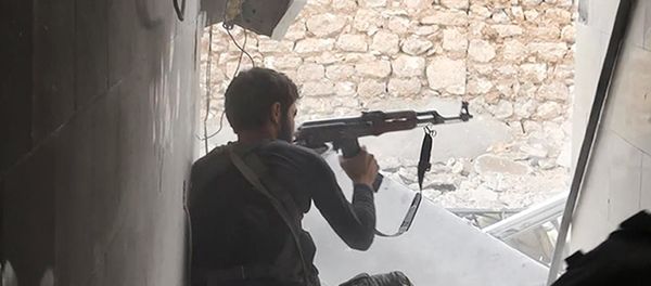 This undated photo posted on Monday, Nov. 4, 2014 by the Raqqa Media Office of the Islamic State group, a militant extremist group, shows an Islamic state group fighter in Kobani, Syria This undated photo posted on Monday, Nov. 4, 2014 by the Raqqa Media Office of the Islamic State group, a militant extremist group, shows an Islamic state group fighter in Kobani, Syria - Sputnik International