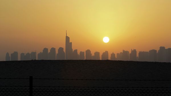 The sun sets behind the city skyline at the Marina district as the Almas tower is seen in Dubai, United Arab Emirates - Sputnik International