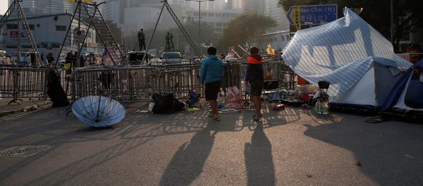 Pro-democracy protesters stand at an occupied area before barricades are removed outside government headquarters in Hong Kong's Admiralty district Tuesday, Nov. 18, 2014. Pro-democracy protesters stand at an occupied area before barricades are removed outside government headquarters in Hong Kong's Admiralty district Tuesday, Nov. 18, 2014. - Sputnik International