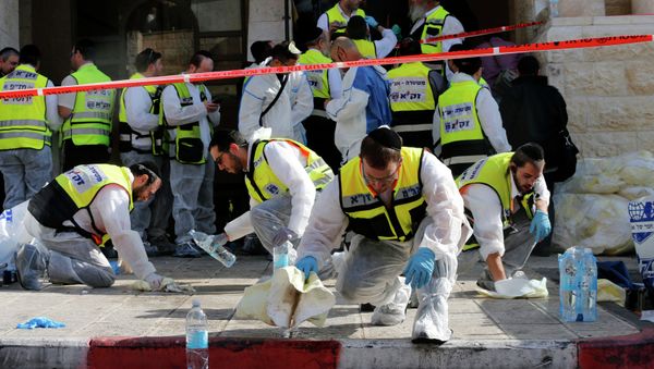 Members of the Israeli Zaka emergency response team clean blood from the scene of an attack at a Jerusalem synagogue Members of the Israeli Zaka emergency response team clean blood from the scene of an attack at a Jerusalem synagogue - Sputnik International