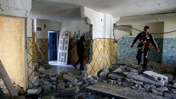 Relatives of Abdel-Rahman Shaloudi walk on rubble in his destroyed home in the East Jerusalem neighbourhood of Silwan November 19, 2014 - Sputnik International