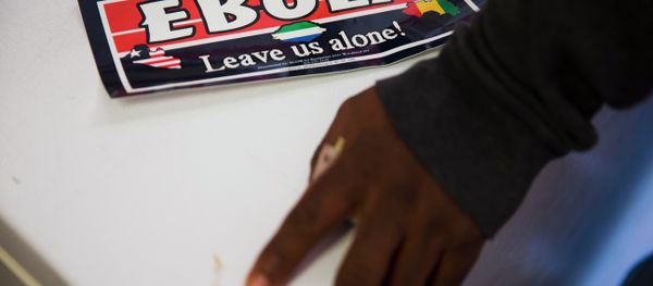 An Ebola bumper sticker sits next to Sierra Leone immigrant Mamud Jalloh's hand Wednesday, Oct. 8, 2014, in Philadelphia An Ebola bumper sticker sits next to Sierra Leone immigrant Mamud Jalloh's hand Wednesday, Oct. 8, 2014, in Philadelphia - Sputnik International