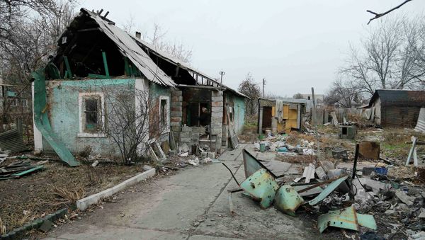 A man enters a destroyed house in the Spartak area near Sergey Prokofiev International Airport in Donetsk November 18, 2014 - Sputnik International